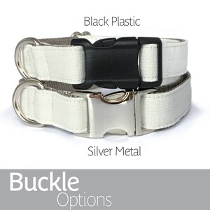 May include: Two dog collars with different buckle options. The top collar has a black plastic buckle and the bottom collar has a silver metal buckle. Both collars are white.