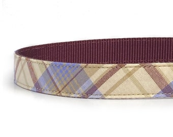 May include: A burgundy and tan plaid dog collar with a burgundy underside.