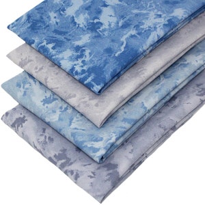 May include: Four pieces of fabric stacked, featuring a blue and grey marbled pattern. The fabric is soft and has a subtle sheen.