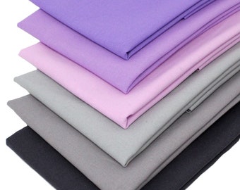 May include: Five fabric swatches in shades of purple, pink, and gray. The swatches are folded and stacked on top of each other.