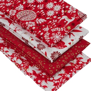 May include: A stack of five red and white fabric squares with a gold metallic print. The fabric features a variety of winter-themed designs, including snowflakes, trees, birds, and deer.