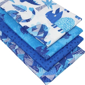 May include: A stack of four blue and white fabric squares featuring a dinosaur and geometric pattern. The fabric is ideal for quilting, crafts, and home decor projects.