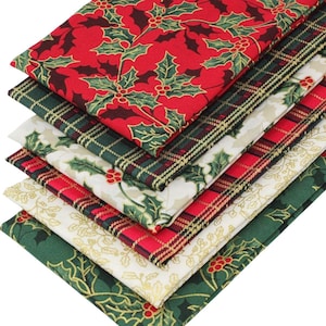 May include: A stack of six folded fabric pieces featuring various holiday-themed patterns. The designs include red holly leaves with berries, dark green and black plaid, cream with holly, red and black plaid, cream with gold holly, and dark green holly.