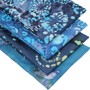May include: Stack of five blue and white batik fabric squares. The fabric has a swirling pattern with shades of blue and white.