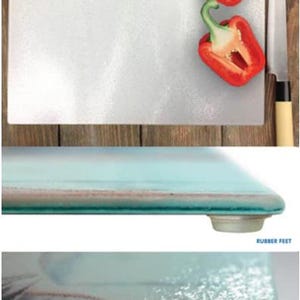 May include: A white glass cutting board with a textured surface. The board has rubber feet on the bottom to prevent slipping. The board is shown with two red bell peppers and a knife.