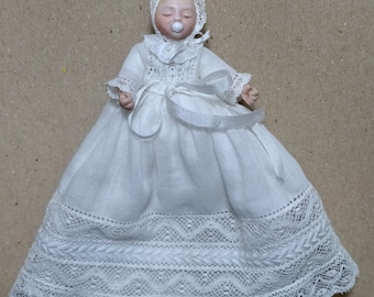 Bebé con faldón y gorro de encajes antiguos, porcelana, articulada escala 1:12 para casa de muñecas.