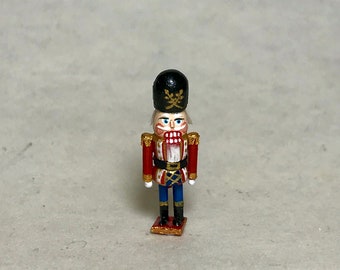 Miniature nutcracker, scale 1:12. 25-28 mm in height.  Wood carved and painted by hand.