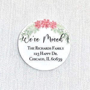 May include: A round, white sticker with a floral border and the text "We've Moved!" The Richards Family, 123 Happy Dr., Chicago, IL 60639.