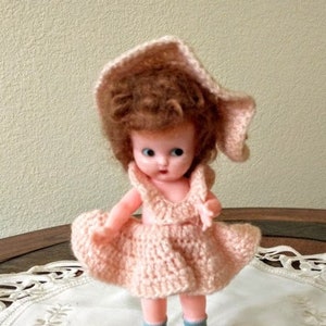 Vintage Knickerbacker Rattle Doll with Crocheted Outfit on stand