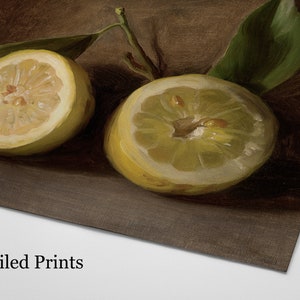 May include: A still life print featuring two halved lemons with green leaves. The lemons are a vibrant yellow, with visible seeds and a textured rind. The background is a dark brown, creating a contrast with the bright fruit. The text "Mailed Prints" is at the bottom.