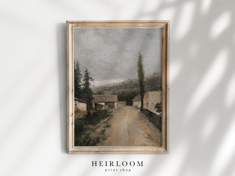 May include: A vintage oil painting depicting a rural scene with a dirt road leading through a small village. The houses are white with brown roofs, and there are trees and hills in the background. The sky is a muted gray, and the overall tone of the painting is peaceful and serene.