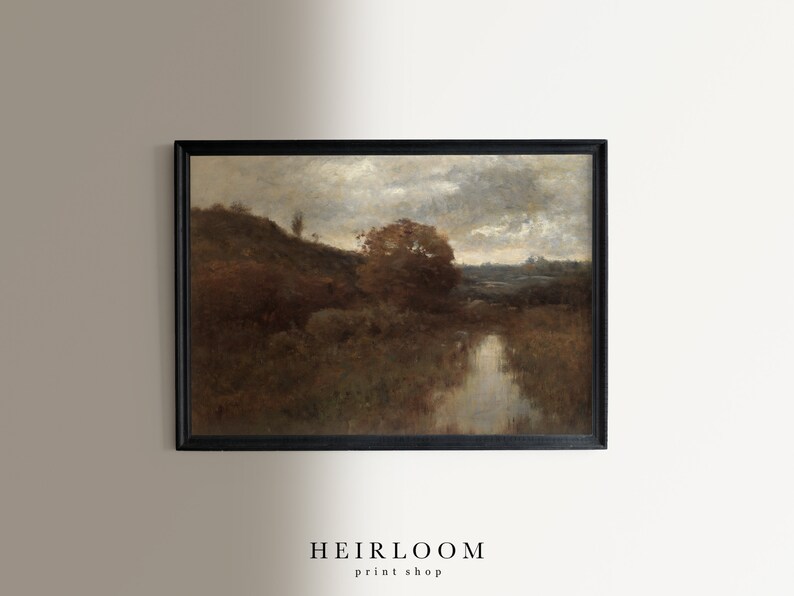May include: A framed painting of a landscape with a river, trees, and a cloudy sky. The painting is in a dark brown frame.