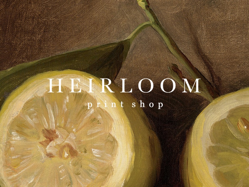 May include: A still-life painting featuring a sliced lemon with a bright yellow interior and a green leaf. The text "HEIRLOOM print shop" is displayed in white letters.