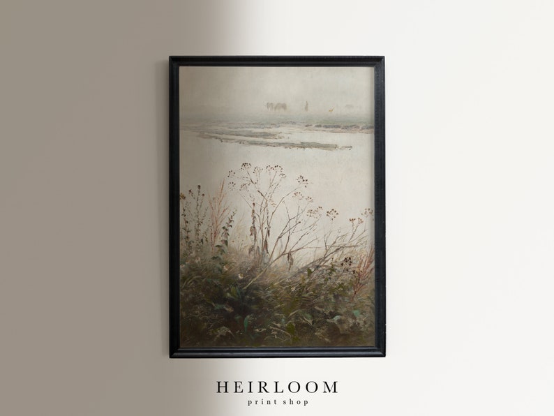 May include: A framed landscape painting with a muted color palette. The artwork depicts a misty, overcast scene with a body of water and sparse vegetation in the foreground. The frame is black, and the text "HEIRLOOM print shop" is at the bottom.