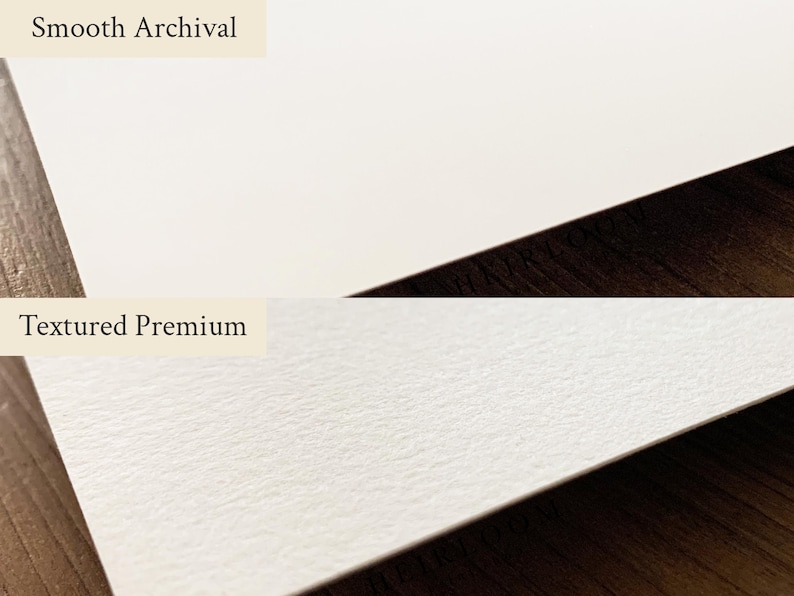 May include: A side-by-side comparison of two types of paper. The top section displays smooth, white paper labeled "Smooth Archival." The bottom section shows textured, off-white paper labeled "Textured Premium." Both papers are on a dark wood surface.