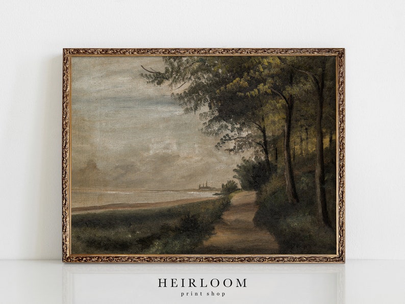 May include: A framed painting of a landscape with a path leading through a forest towards a body of water. The sky is cloudy and the colors are muted.