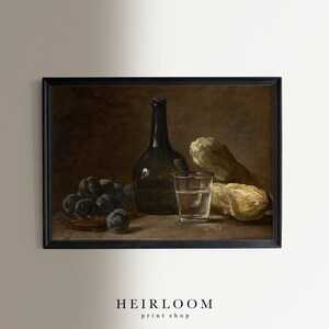 May include: A framed still life print featuring a dark bottle, a glass of water, plums in a basket, and two gourds. The print has a vintage aesthetic with a dark, moody color palette. The text "HEIRLOOM print shop" is at the bottom.