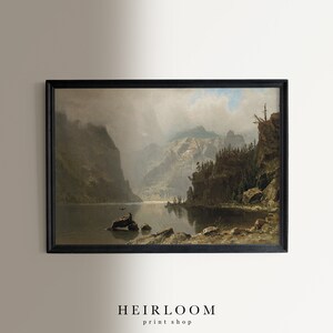 May include: Framed landscape art print featuring a serene lake scene surrounded by towering mountains. The artwork is in muted tones of gray, brown, and green, with a black frame. The text "HEIRLOOM print shop" is at the bottom.