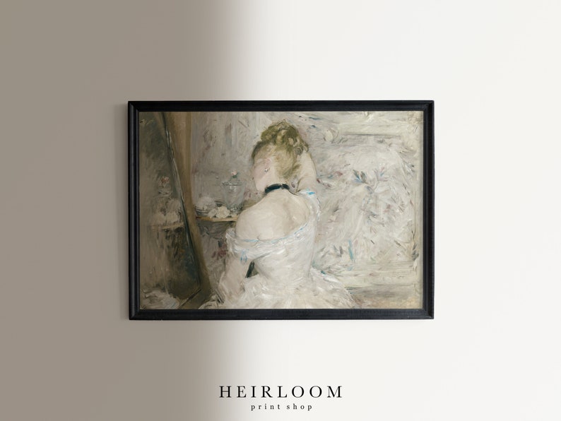 May include: A painting of a woman in a white dress, sitting in front of a mirror, with her hair up. The painting is in a black frame.
