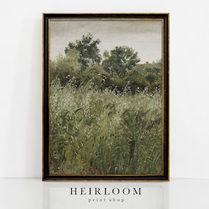 May include: A framed landscape painting depicting a field of tall green grass and wildflowers, with trees in the background under a cloudy sky. The artwork has a vintage aesthetic, with a dark wooden frame and the text "HEIRLOOM print shop" at the bottom.