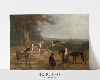 May include: A vintage-style print featuring a group of greyhounds in a natural setting. The artwork depicts several dogs in various poses, with a muted color palette of browns, greens, and grays. The print includes the text "HEIRLOOM print shop".