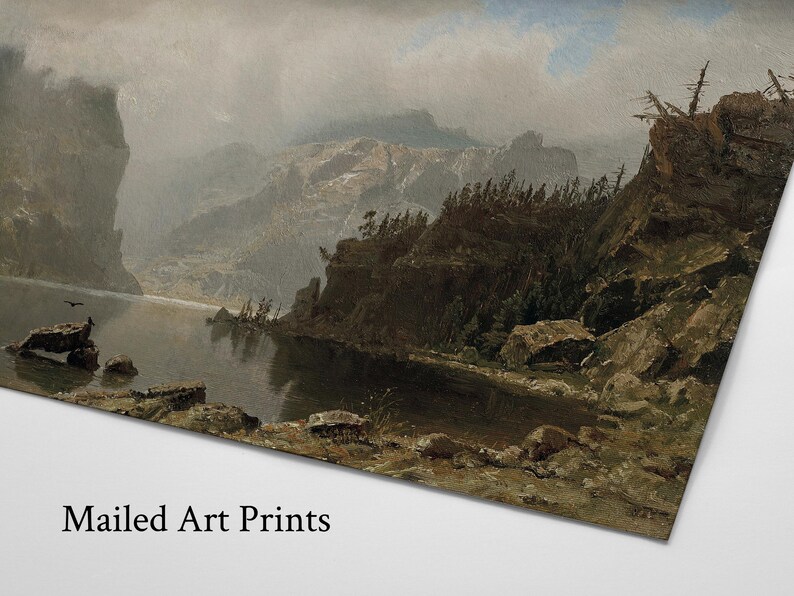 May include: A landscape art print depicts a serene lake surrounded by rocky cliffs and mountains under a cloudy sky. The artwork features muted tones of gray, brown, and green, with the text "Mailed Art Prints" at the bottom.