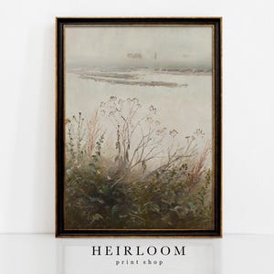 May include: A framed vintage landscape print featuring a misty marsh scene with tall grasses and distant figures. The artwork has a muted color palette of greens, browns, and grays, with a black and gold frame. The text "HEIRLOOM print shop" is at the bottom.