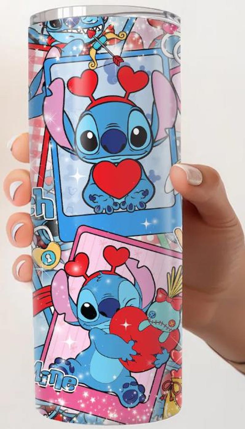 May include: A stainless steel tumbler featuring a cartoon character with a blue body, large eyes, and heart-shaped accents. The design includes the character holding a heart, set against a pink and blue background with the word "Love".