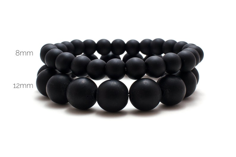 May include: Two black beaded bracelets, one with 8mm beads and one with 12mm beads.