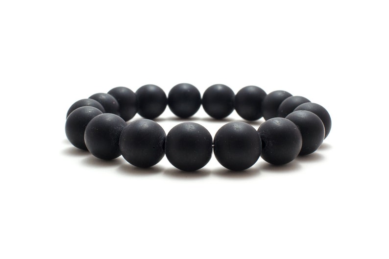 May include: A black beaded bracelet with round, matte black beads.