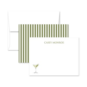 May include: White stationery set featuring a martini illustration and the name "CASEY MONROE" in a serif font. The set includes a white envelope, a card with olive green stripes, and a white card with a martini glass.