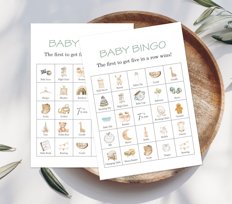 May include: A printable baby bingo card with illustrations of baby items like a high chair, booties, a rattle, a baby cap, a comb, a giraffe, a teddy bear, a diaper, a moon, a rocking chair, a sweater, a bath tub, a baby book, a charging table, a mobile, a teether, a stacking toy, a hanger, a blanket, a rainbow, a wall decor, a onesie, a tent, a rattle, a pair of socks, a bunny, a safety pin, a balloon, and shoes. The card has the text "Baby Bingo" and "The first to get five in a row wins!"