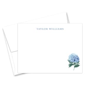 May include: A white stationery card with a blue hydrangea illustration and the text "TAYLOR WILLIAMS" printed in blue at the top.
