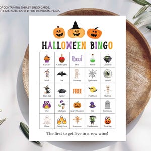 May include: A Halloween Bingo game card featuring a grid of 25 squares with colorful illustrations of pumpkins, a witch, a ghost, and other holiday icons. The text reads A PDF CONTAINING 50 BABY BINGO CARDS, EACH CARD SIZED 8.5" X 11" ON INDIVIDUAL PAGES.