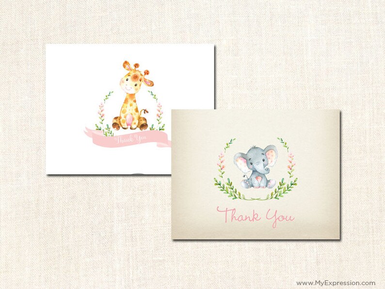 May include: Two thank you cards with a pink floral wreath design. One card features a giraffe with brown spots and the other card features a gray elephant with pink ears. Both cards have the text "Thank You" in pink.