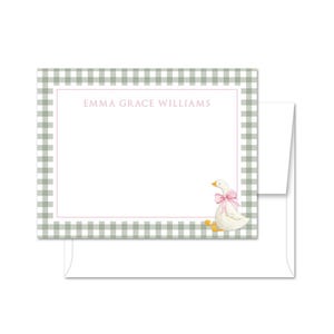May include: Stationery set featuring a white card with a green and white gingham border. The card includes the text "EMMA GRACE WILLIAMS" in pink, and a watercolor illustration of a goose with a pink bow. A white envelope is included.