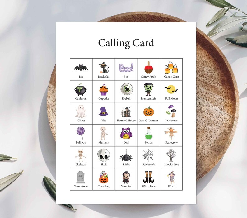 May include: A white rectangular calling card featuring a grid of twenty-five Halloween-themed illustrations. Each square contains a small icon such as a bat, black cat, ghost, pumpkin, or spider, with the corresponding label printed in black text below.