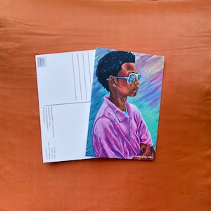 May include: A postcard featuring a painting of a young person wearing sunglasses and a pink shirt. The background is a colorful abstract design.
