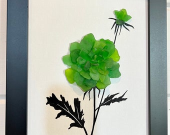 Green Sea Glass flower with hand drawn stem and leaves using black Indian ink. The piece comes framed with a variety of colors to choose