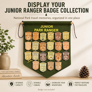 May include: A green canvas Junior Ranger badge display banner with wooden dowels and a hanging cord. The banner features a collection of Junior Ranger badges from various National Parks. Text on the banner reads "DISPLAY YOUR JUNIOR RANGER BADGE COLLECTION".