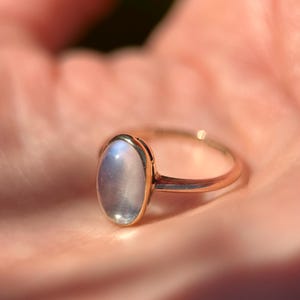 A very sweet antique late Victorian moonstone and 9 carat gold ring, circa 1890-1900