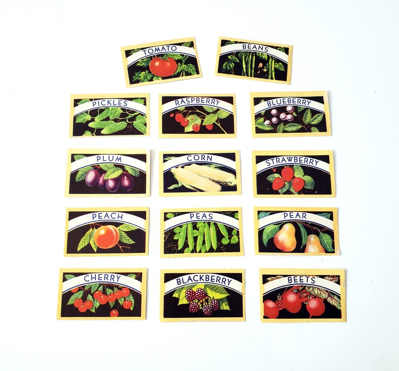 May include: A set of 12 vintage-style cards featuring various fruits and vegetables. Each card has a yellow background with a blue border and a white title. The cards include: Tomato, Beans, Pickles, Raspberry, Blueberry, Plum, Corn, Strawberry, Peach, Peas, Pear, Cherry, Blackberry, and Beets.
