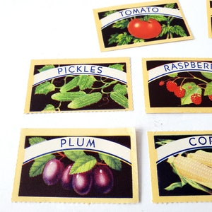 May include: Six vintage yellow cards with blue and white text and illustrations of various fruits and vegetables. The cards read "TOMATO", "PICKLES", "RASPBERRY", "PLUM", "CORN", and "BEANS".