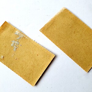 May include: Two rectangular pieces of brown paper. One piece has white spots on it.