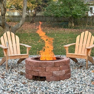 Raw steel DIY smokeless fire pit kit, with visible natural patina from outdoor use with sizeable smokeless fire with two chairs.