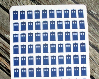 May include: A sheet of 100 blue TARDIS stickers. The stickers are arranged in a grid pattern on a white background. The text "Little Pixie Paperie" is at the bottom of the sheet.
