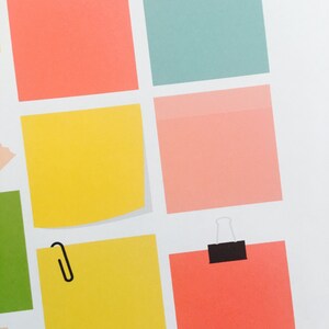 May include: A set of colorful sticky notes with paper clips and tape. The notes are in various colors, including yellow, pink, blue, and orange.
