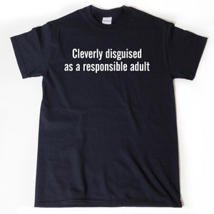 May include: A dark blue t-shirt with the text "Cleverly disguised as a responsible adult" printed in white on the front.