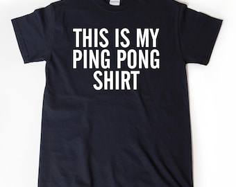 May include: A black t-shirt with white text that reads "This is my ping pong shirt."