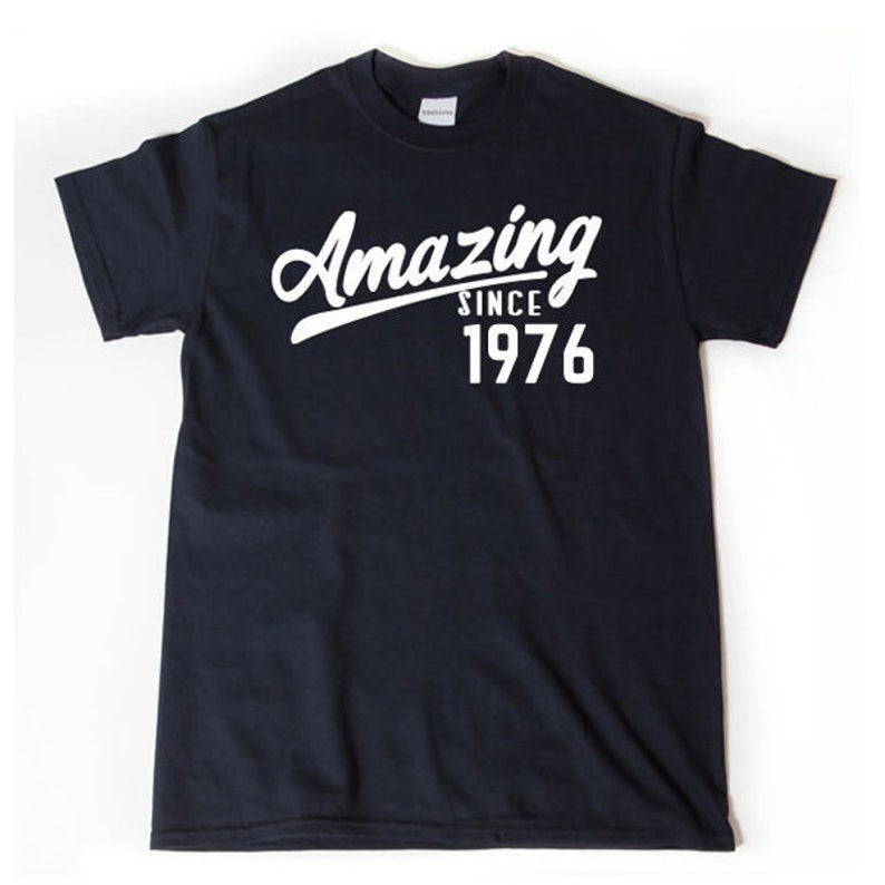 May include: A black t-shirt with white text that reads "Amazing Since 1976".